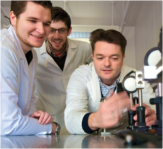 CSUEB students Trevor Billings, from left, and Keith Penney work in the lab alongside Assistant Professor Erik Helgren
